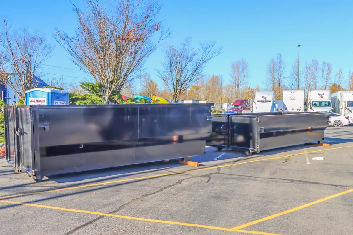 Professional dumpster rental service with roll-off container on residential driveway in South Haven